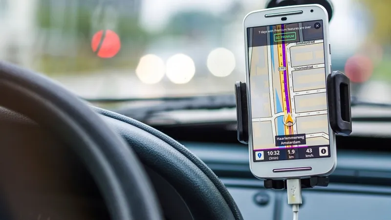 A phone mounted in a car showing turn-by-turn navigation